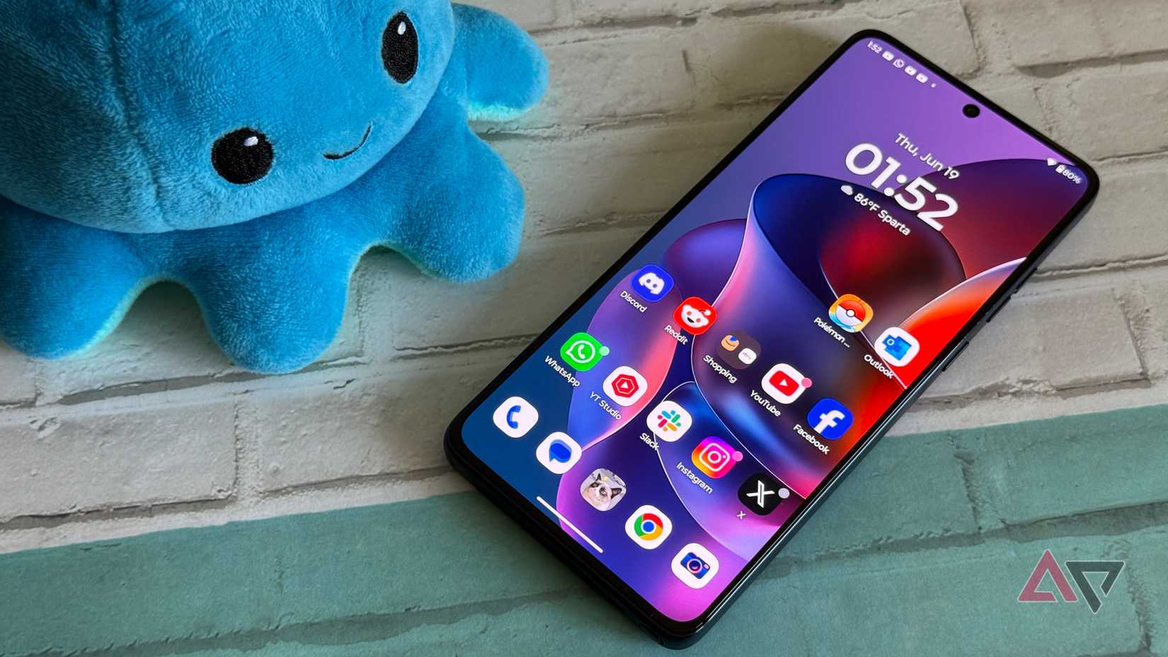 Moto G Stylus 2025 with its home screen open next to Pusheen