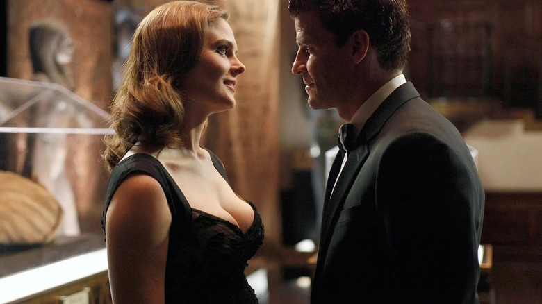 Brennan looking at Booth and smiling