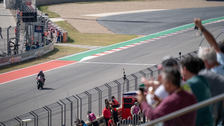 Fans cheer as Jorge Martin crosses the finish line at COTA