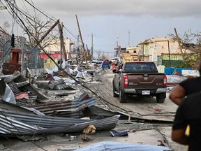 A car drives through a neighbourhood following the passage of Hurricane Melissa, in Black River, Jamaica on Oct. 29, 2025.