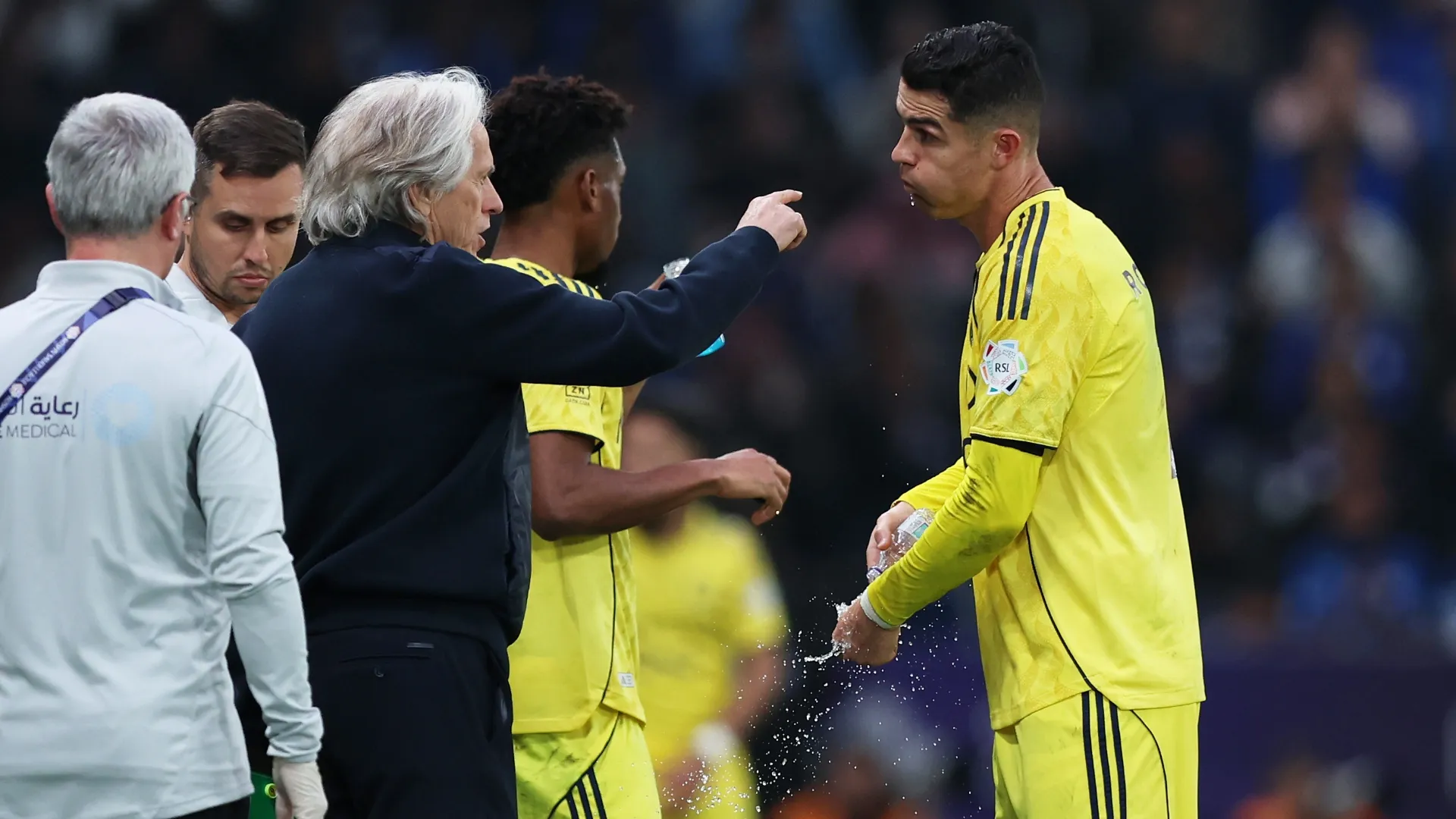 Jorge Jesus, Manager of Al-Nassr, interacts with Cristiano Ronaldo of Al-Nassr.