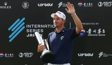 Lucas Herbert waves to fans while holding the International Series Japan trophy in 2025