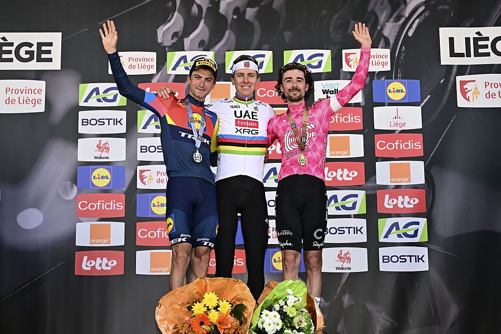 Giulio Ciccone, Tadej Pogacar and Ben Healy celebrate on the podium after the 2025 Liege-Bastogne-Liege