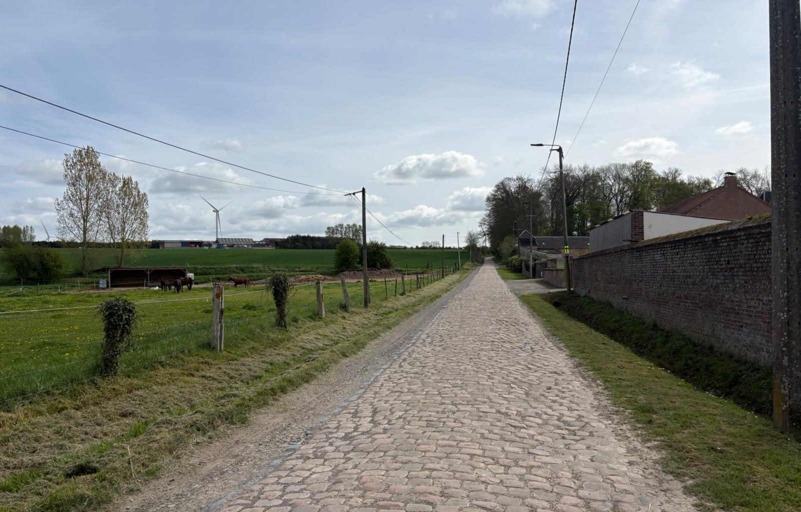 Wide shots of the cobbled section at Briastre, to be used in Paris-Roubaix 2026. The photos show relatively smooth cobbles and a gentle uphill