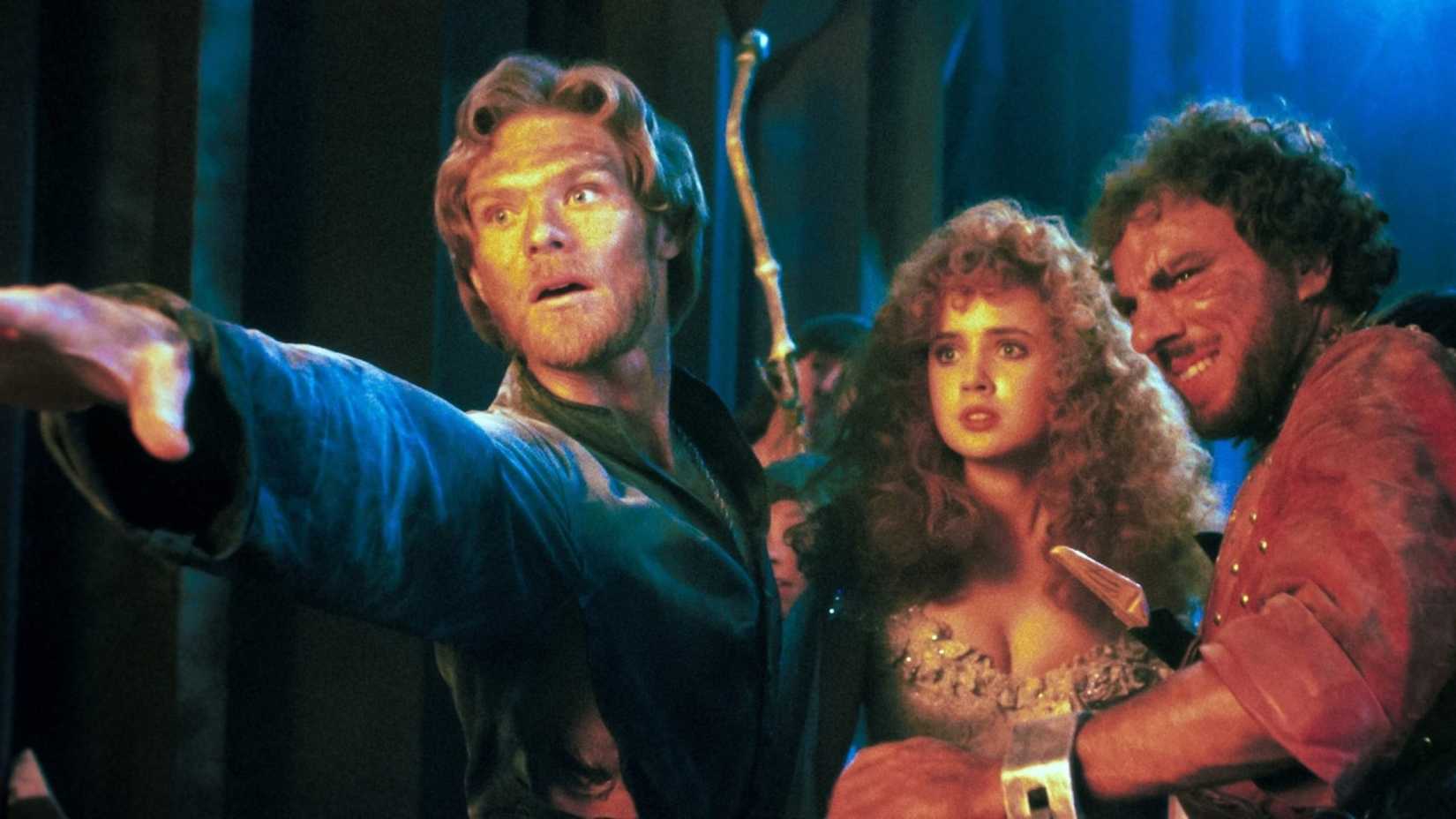 Colwyn standing with his arm outstretched next to Lyssa and Torquil in Krull