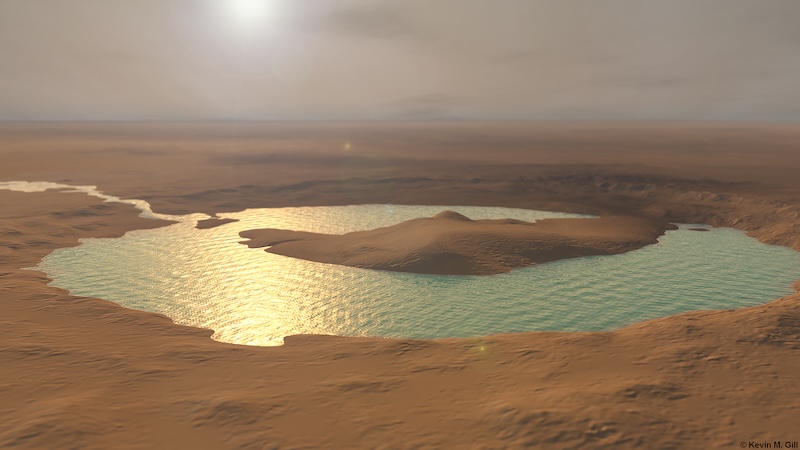 Circular lake with ripples, and aa large island in the middle, in barren reddish landscape under a hazy sky.