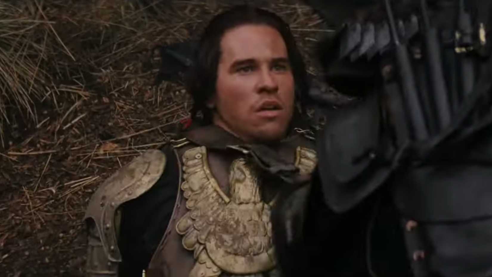 Madmartigan (Val Kilmer) on the ground wearing golden armor in Willow