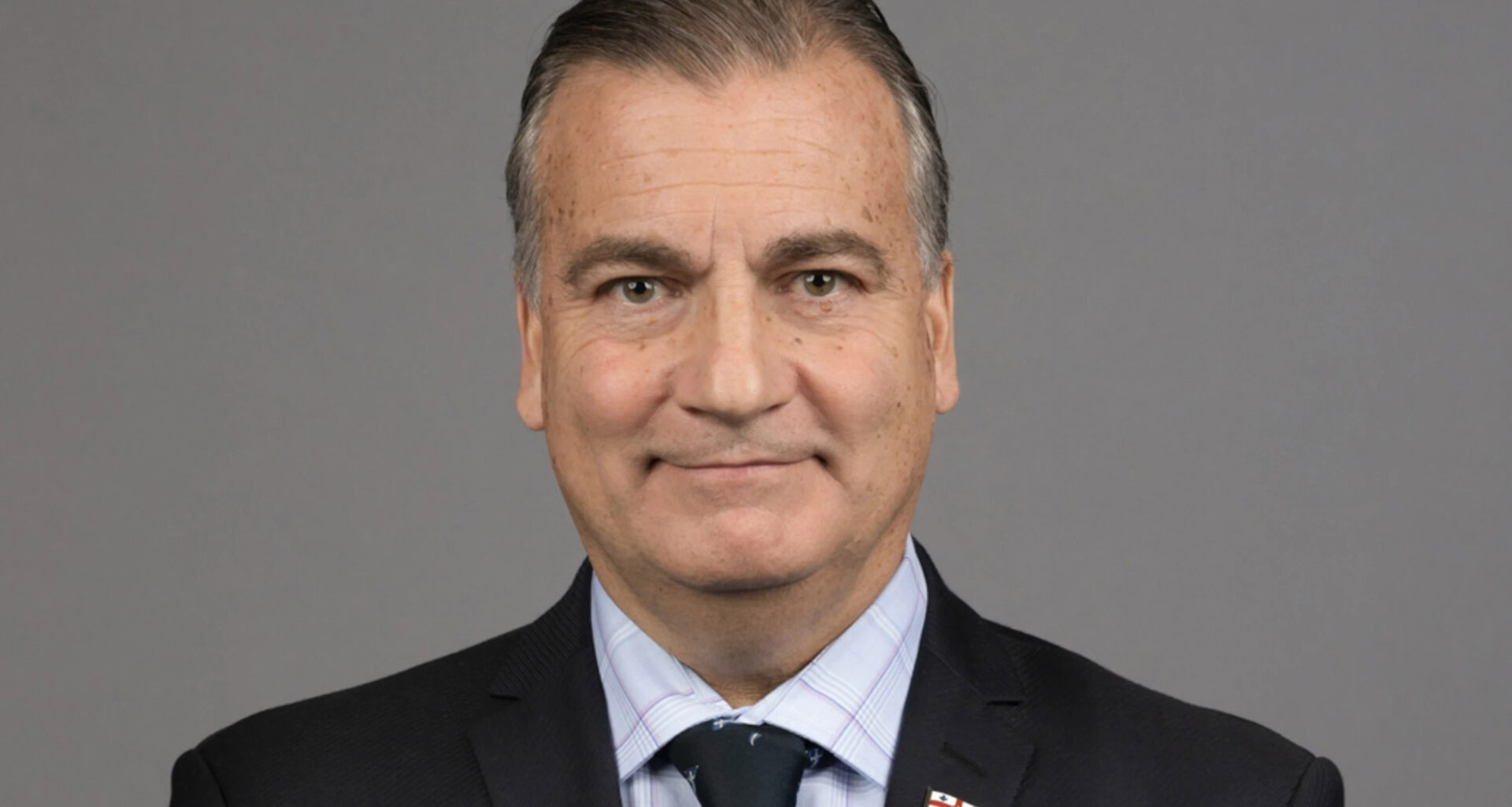 Mauro Barone wears a suit in a closeup professional headshot.