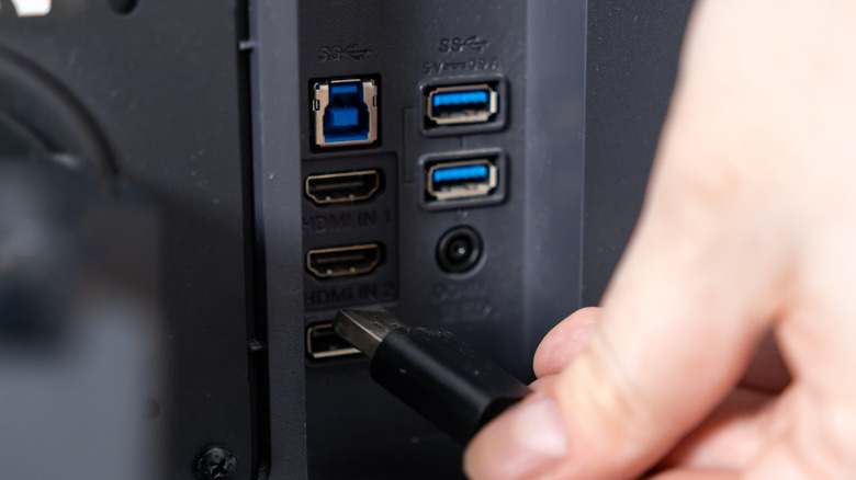 person plugging into HDMI port
