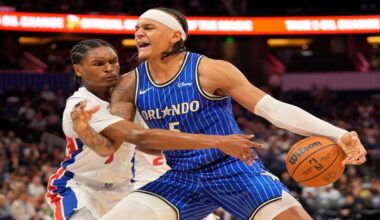 Orlando Magic forward Paolo Banchero, right, makes a move to get around Detroit Pistons guard Ausar Thompson during the second half of an NBA basketball game, Monday, April 6, 2026, in Orlando, Fla. (AP Photo/John Raoux)