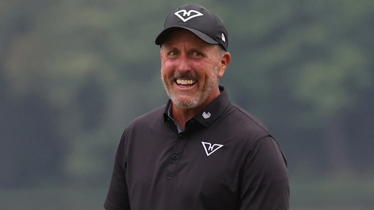 Phil Mickelson smiling after making a flop shot on the seventeenth green at LIV Golf Virginia