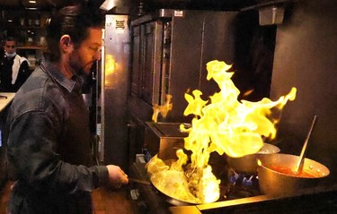Iani Makris works with the flame in the kitchen of Anatoli Souvlaki in North Vancouver. He and his brother co-own the restaurant on Lower Lonsdale.