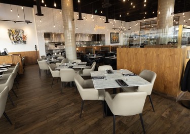 Tables and chairs await customers inside the Piva Modern Italian restaurant in New Westminster.