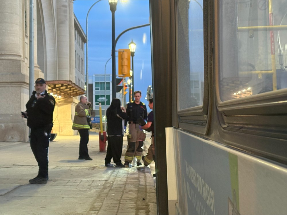 MORGAN MODJESKI / FREE PRESS
Paramedics help a woman after reports of bear spray being discharged on a Winnipeg Transit bus on April 15, 2026.