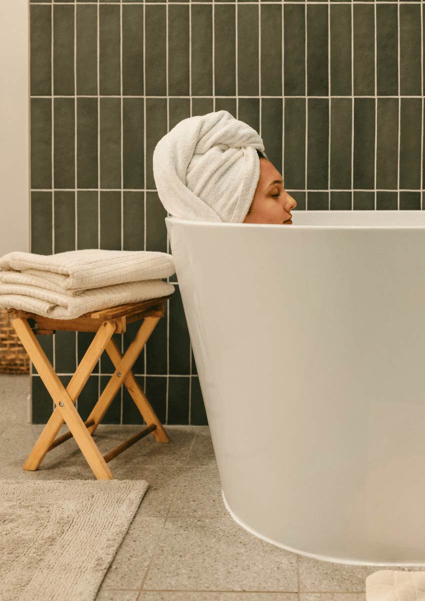 profile of woman sitting in a hot bath