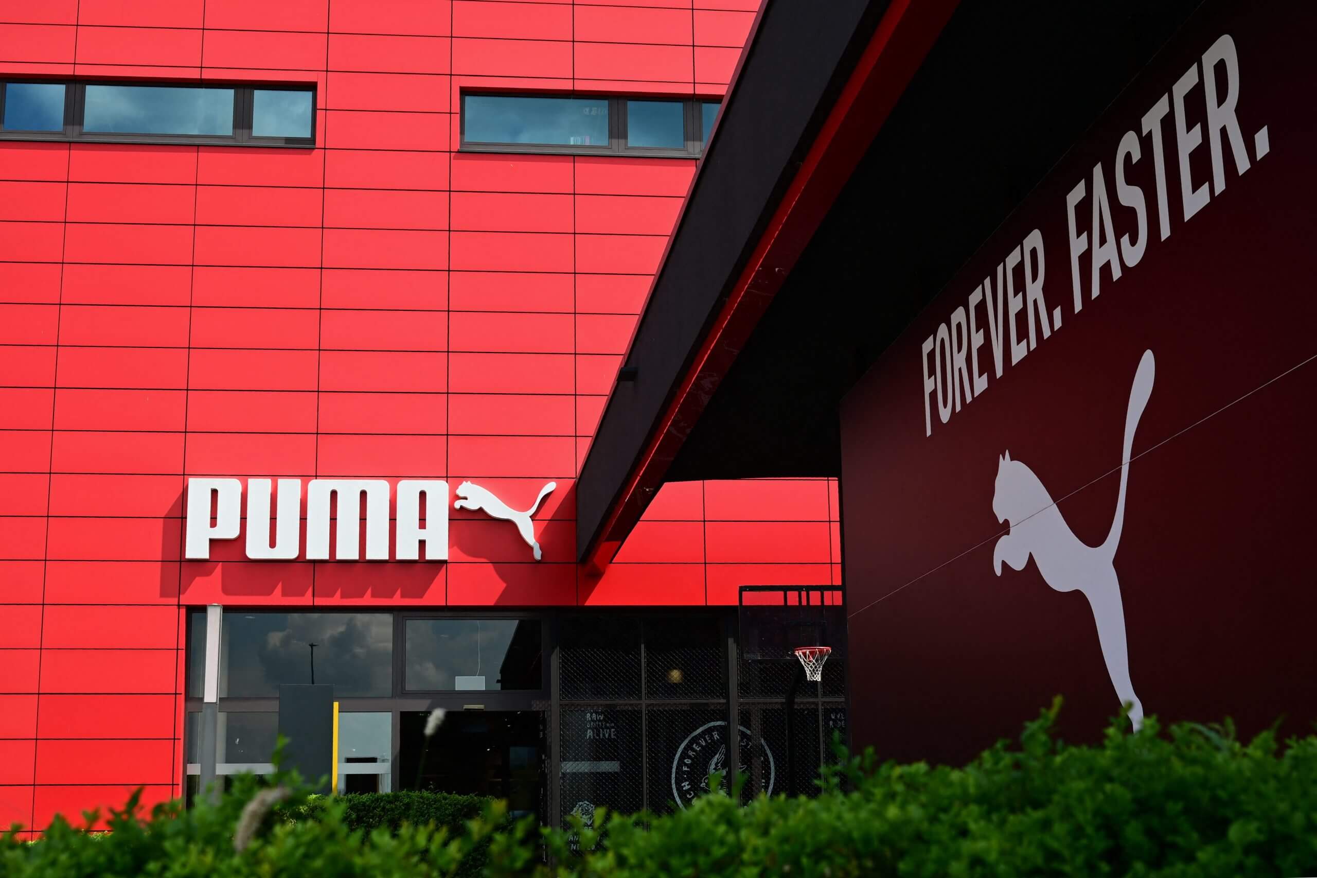 The Puma logo on a red wall at the Puma HQ in Germany