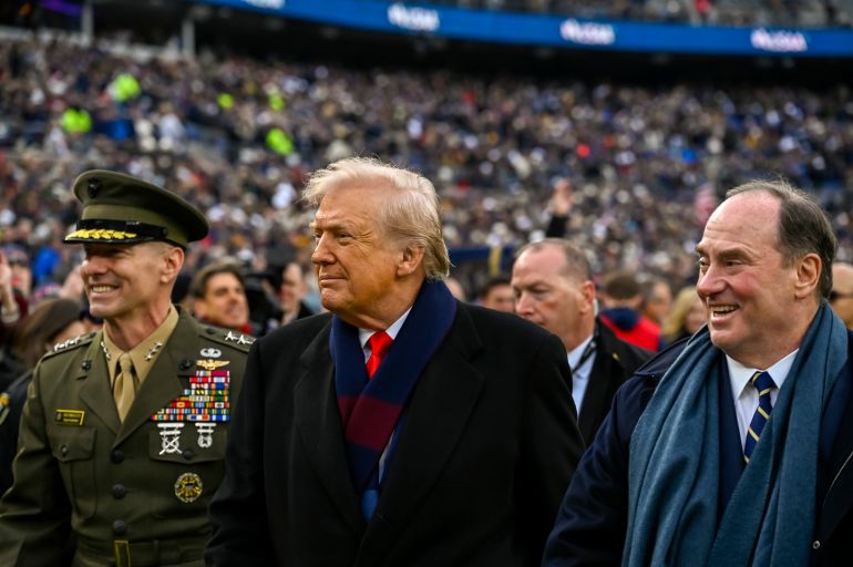 Dec 13, 2025; Baltimore, Maryland, USA; President Donald J Trump walks with U.S. Marine Corps Lieutenant General Michael Borgschulte and Secretary of the Navy John Phelan before the game between the Navy Midshipmen and the Army West Point Black Knights at M&T Bank Stadium. Mandatory Credit: Tommy Gilligan-Imagn Images