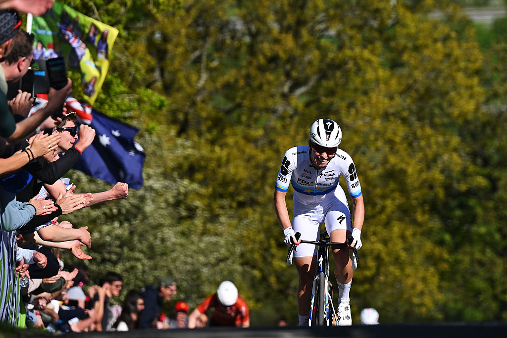 Demi Vollering attacks the favourites at Li&egrave;ge-Bastogne-Li&egrave;ge, crest the climb with fans cheering at the sides of the road.