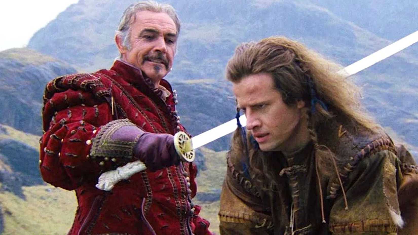 Sean Connery as Juan holding a sword with Christopher Lambert as Connor MacLeod in Highlander