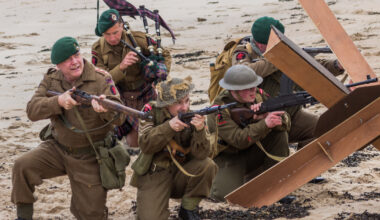 Soldiers with guns on beach