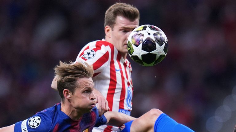 Atletico Madrid's Alexander Sorloth, top, and Barcelona's Frenkie de Jong challenge for the ball