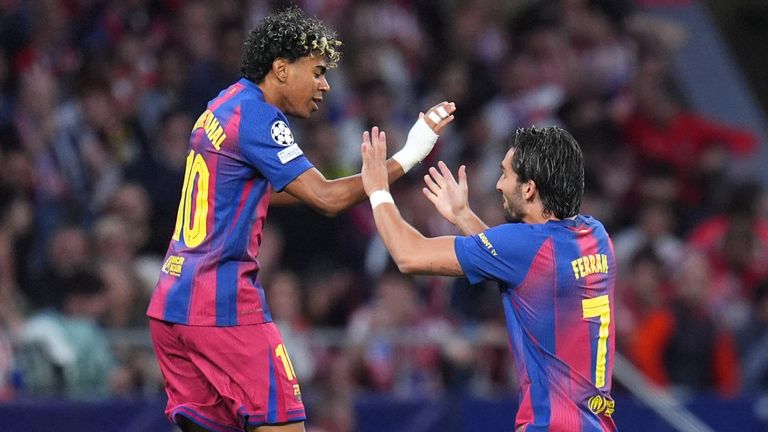 Barcelona's Lamine Yamal, left, celebrates with Barcelona's Ferran Torres after scoring the opening goal during the Champions League quarterfinal second leg soccer match between Atletico Madrid and Barcelona in Madrid, Spain, Tuesday, April 14, 2026. (AP Photo/Manu Fernandez)