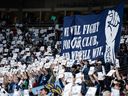Vancouver Whitecaps fans hold signs before the first half of an MLS soccer match against the Colorado Rapids in Vancouver, on Saturday, April 25, 2026.