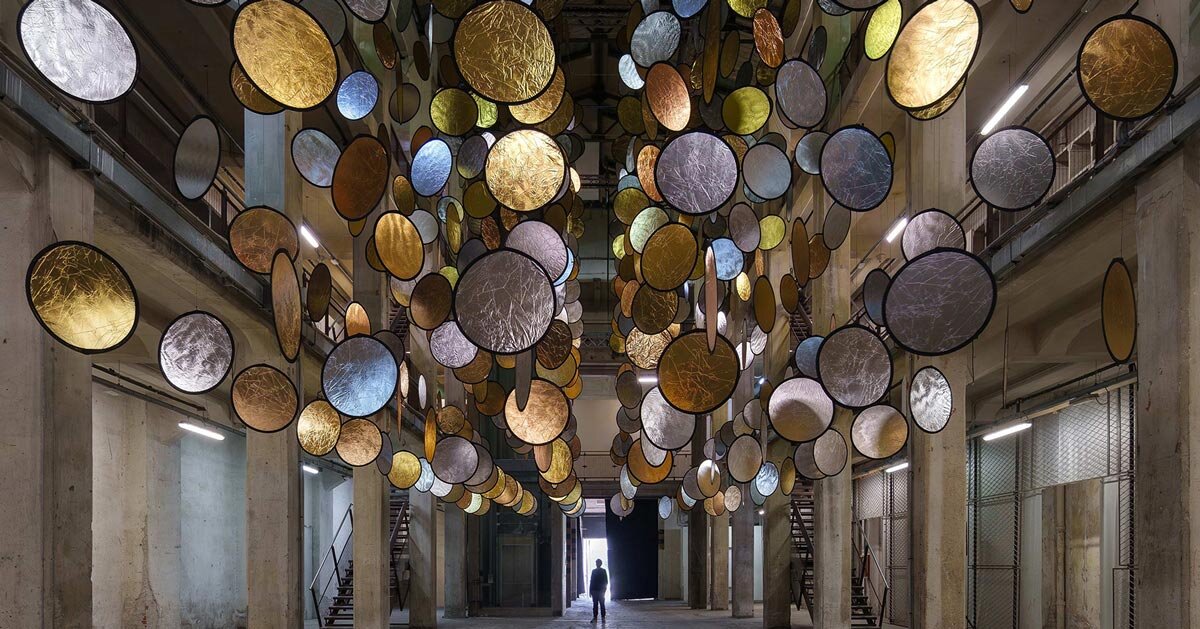 SpY suspends rotating gold and silver halos inside florence atrium