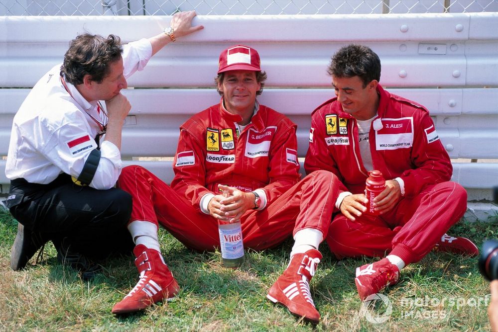 Teammates Gerhard Berger and Jean Alesi chat trackside with team boss Jean Todt before the race.