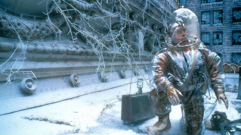 Bruce Willis as James Cole, donning a hazmat suit to explore a post-apocalyptic world in the movie 