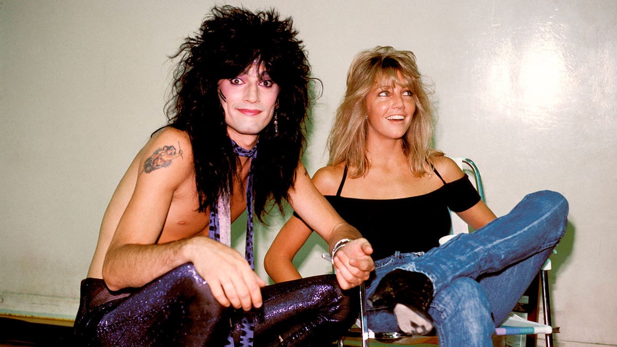 Tommy Lee and Heather Locklear posing backstage.