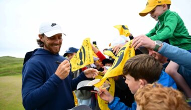 Tommy Fleetwood signs autographs for fans at The Open.