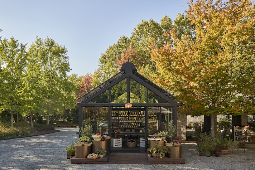 aluminum, timber, and bronze shape greenhouse retail space for culinary produce in madrid - 1