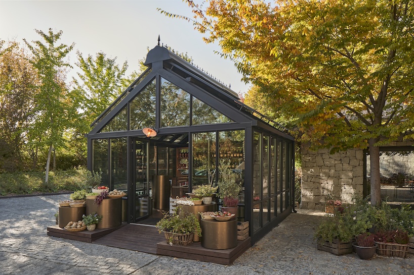 aluminum, timber, and bronze shape greenhouse retail space for culinary produce in madrid - 2