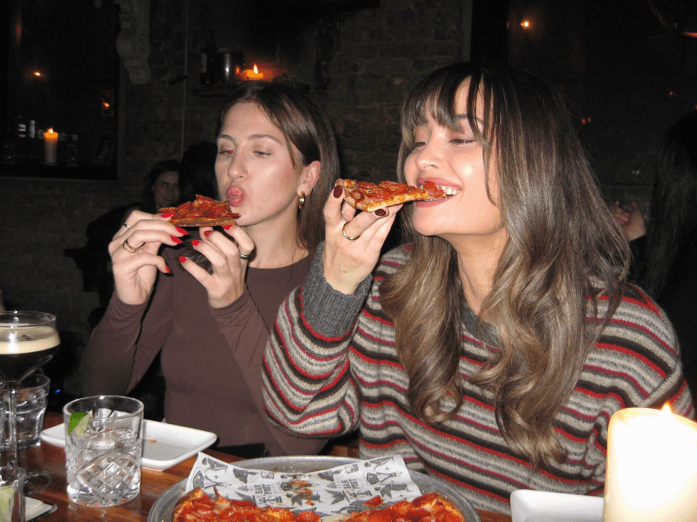 \u200bPeople eating pizza.