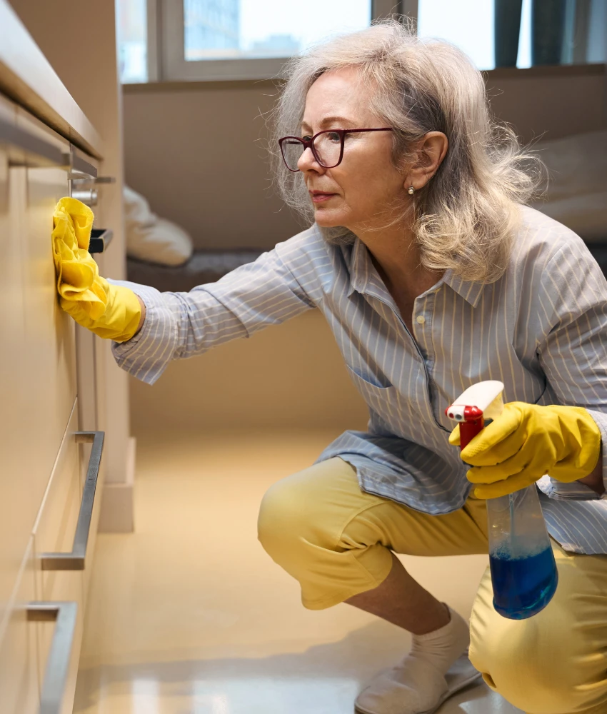 focused person cleans cabinet to manage anxiety
