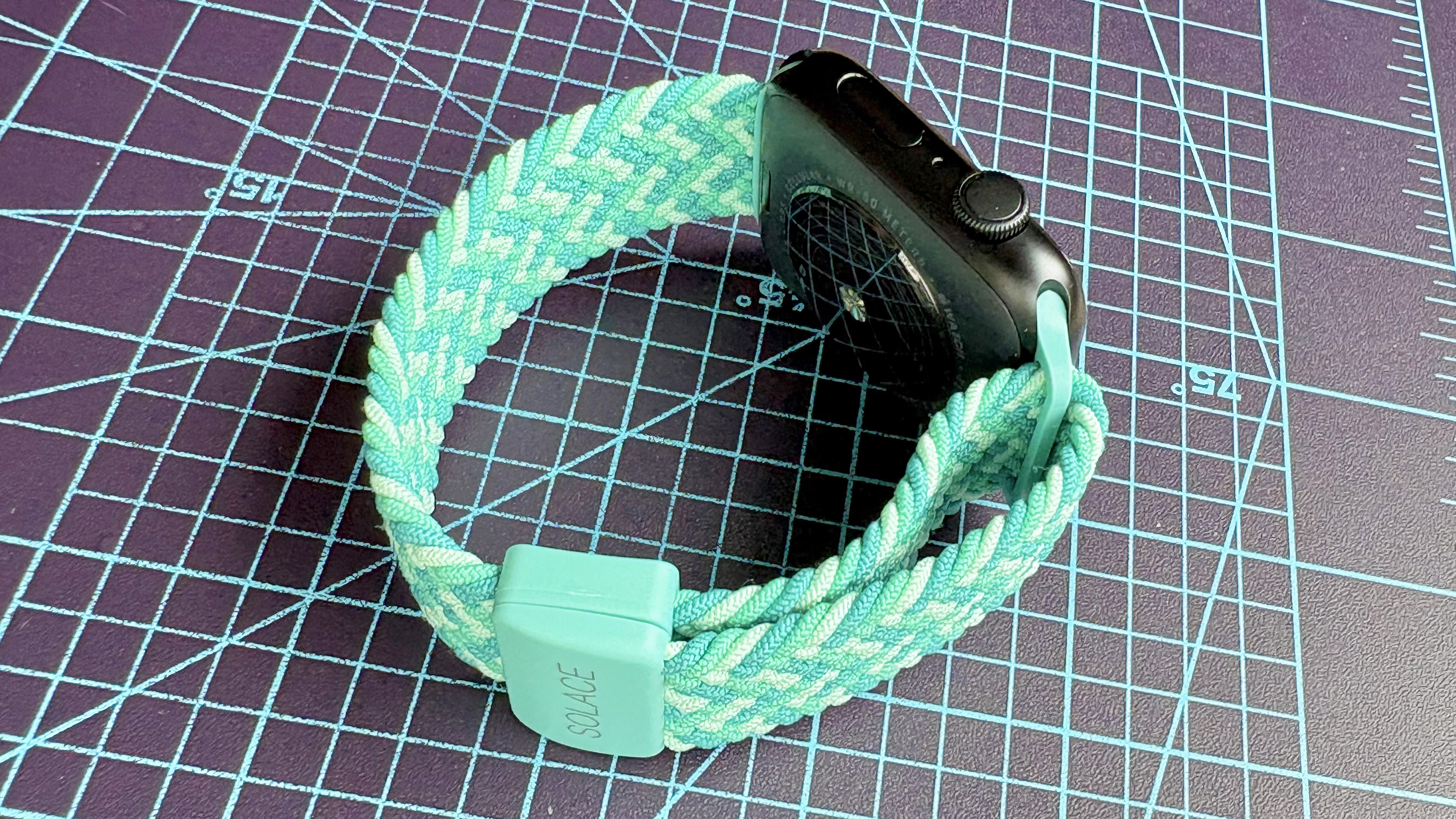 Close-up of the Solace Imperium Adapt watch strap on an Apple Watch SE 3 in 'Calypso' green