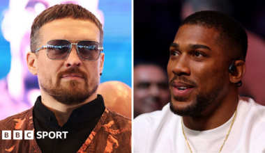 Oleksandr Usyk wearing sunglasses and and orange vest and Anthony Joshua wearing a white t-shirt