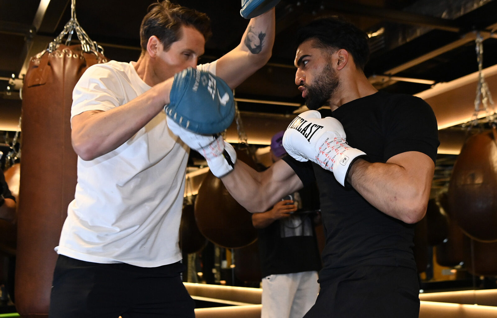 A photograph of super-lightweight boxer Adam Azim, wearing white Everlast gloves, in training at the JAB gym ahead of his 30 May fight with Steve Claggett