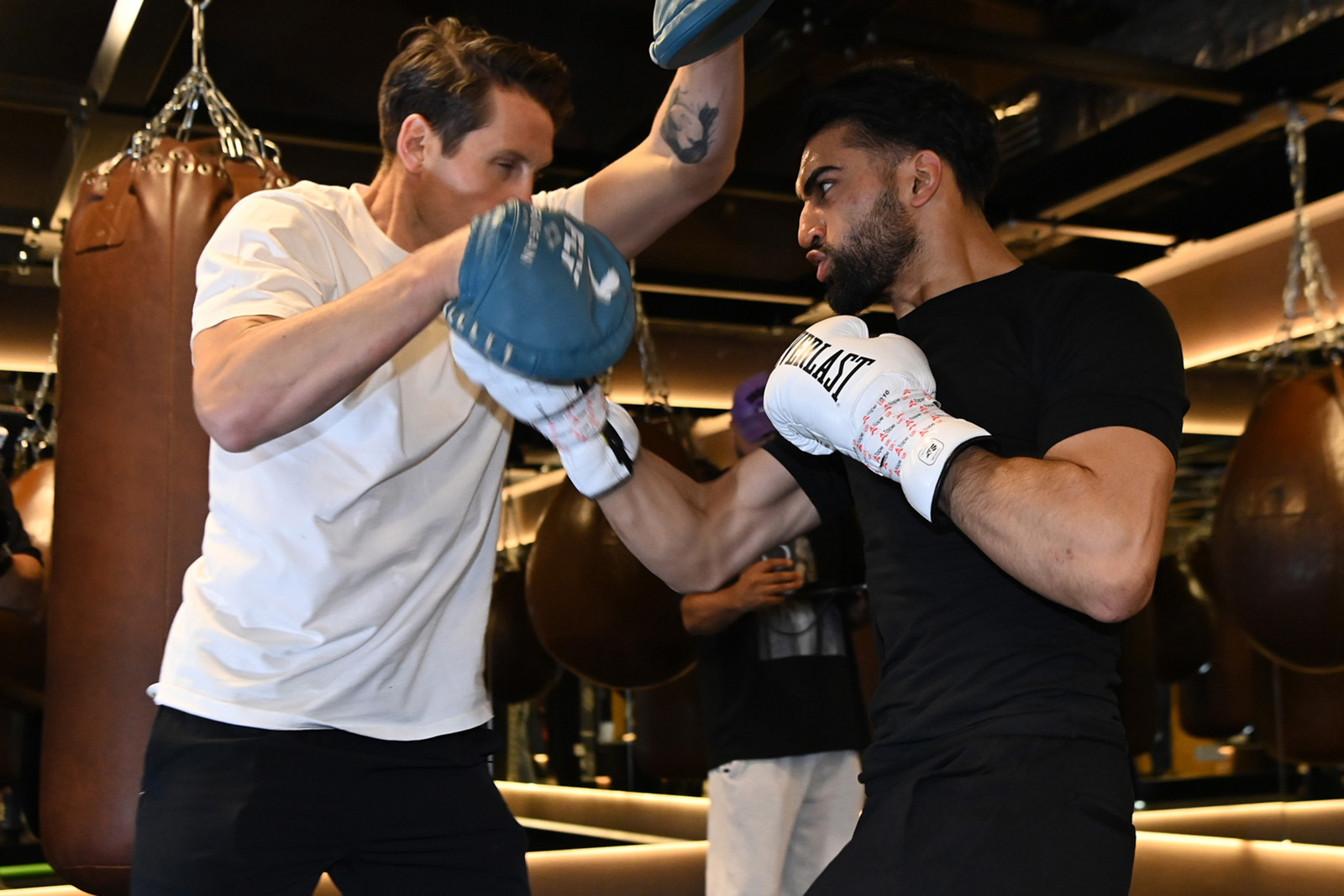 A photograph of super-lightweight boxer Adam Azim, wearing white Everlast gloves, in training at the JAB gym ahead of his 30 May fight with Steve Claggett