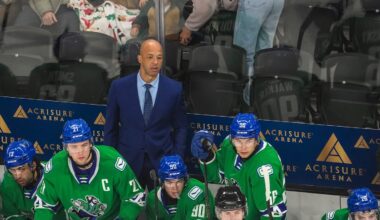 Abbotsford head coach Manny Malhotra watches his team from the bench during the first period of their game at Acrisure Arena in Palm Desert, Calif., Wednesday, Jan. 29, 2025.