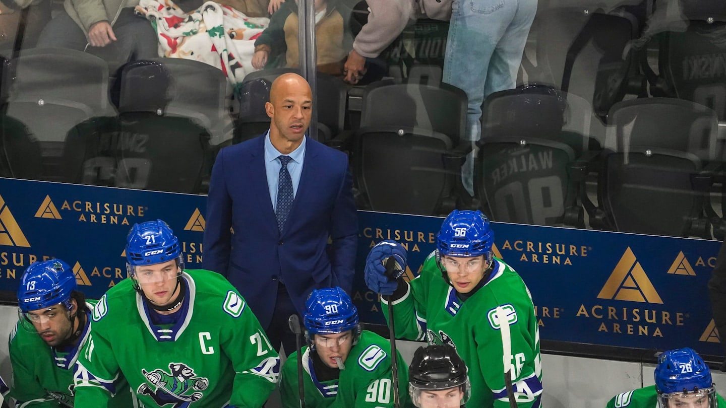 Abbotsford head coach Manny Malhotra watches his team from the bench during the first period of their game at Acrisure Arena in Palm Desert, Calif., Wednesday, Jan. 29, 2025.