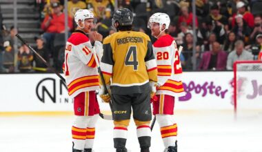 Apr 2, 2026; Las Vegas, Nevada, USA; Vegas Golden Knights defenseman Rasmus Andersson (4) talks with Calgary Flames center Mikael Backlund (11) an left wing Blake Coleman (20) as repairs are made to the ice before the start of the third period at T-Mobile Arena. Mandatory Credit: Stephen R. Sylvanie-Imagn Images