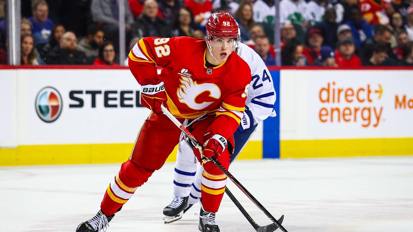 Feb 2, 2026; Calgary, Alberta, CAN; Calgary Flames right wing Matvei Gridin (92) controls the puck against Toronto Maple Leafs center Scott Laughton (24) during the second period at Scotiabank Saddledome. Mandatory Credit: Sergei Belski-Imagn Images
