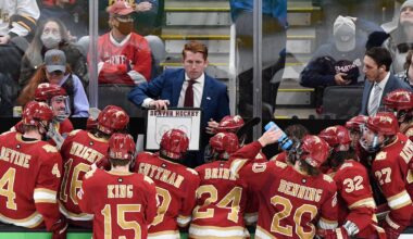 Apr 9, 2022; Boston, MA, USA; Denver Pioneers head coach David Carle talks with his team during a timeout during the third period of the 2022 Frozen Four college ice hockey national championship game against the Minnesota State Mavericks at TD Garden. Mandatory Credit: Brian Fluharty-Imagn Images