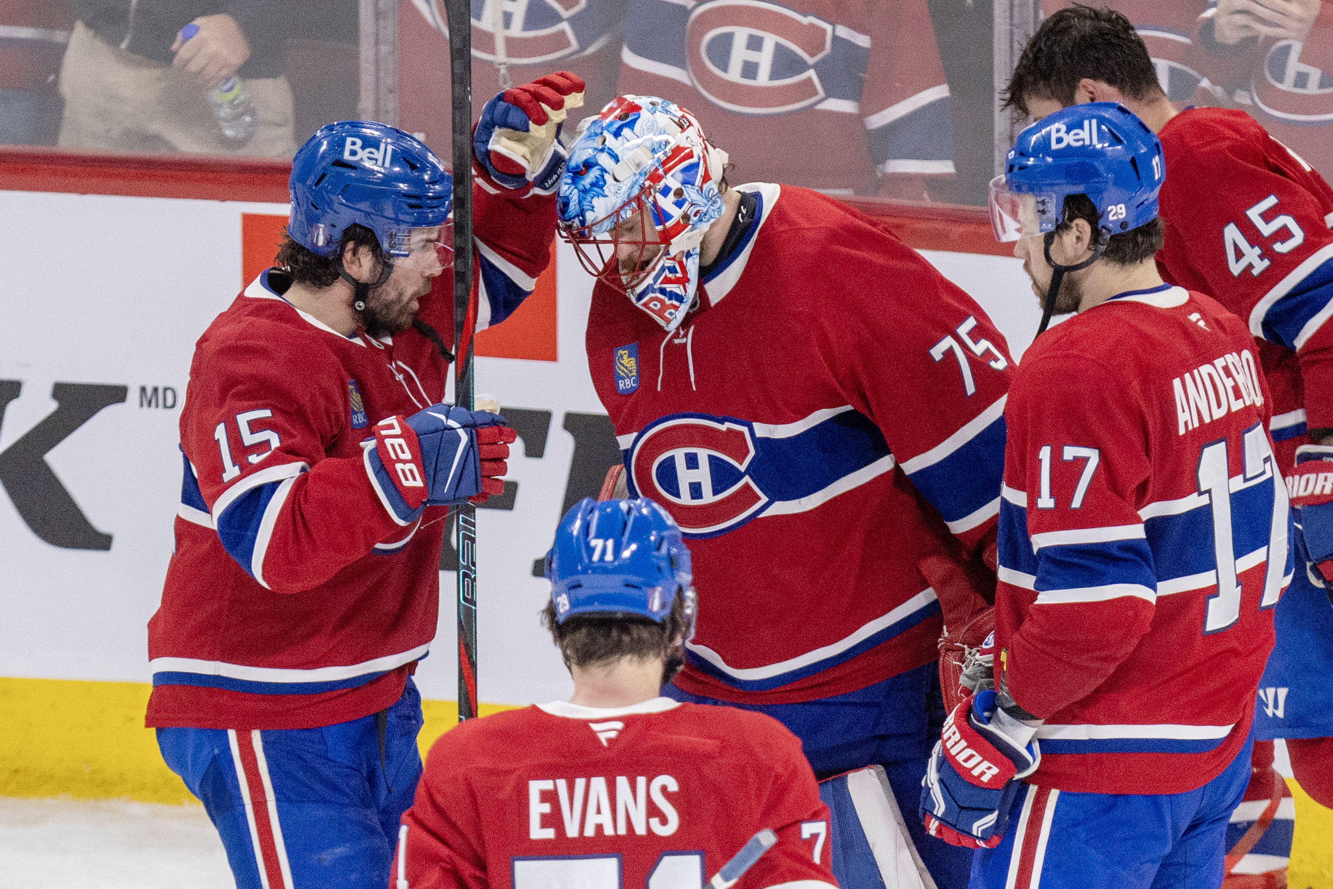 Montreal Canadiens' Alex Newhook congratulates goalie Jakub Dobes, joined by Jake Evans, Josh Anderson and Alex Carrier.