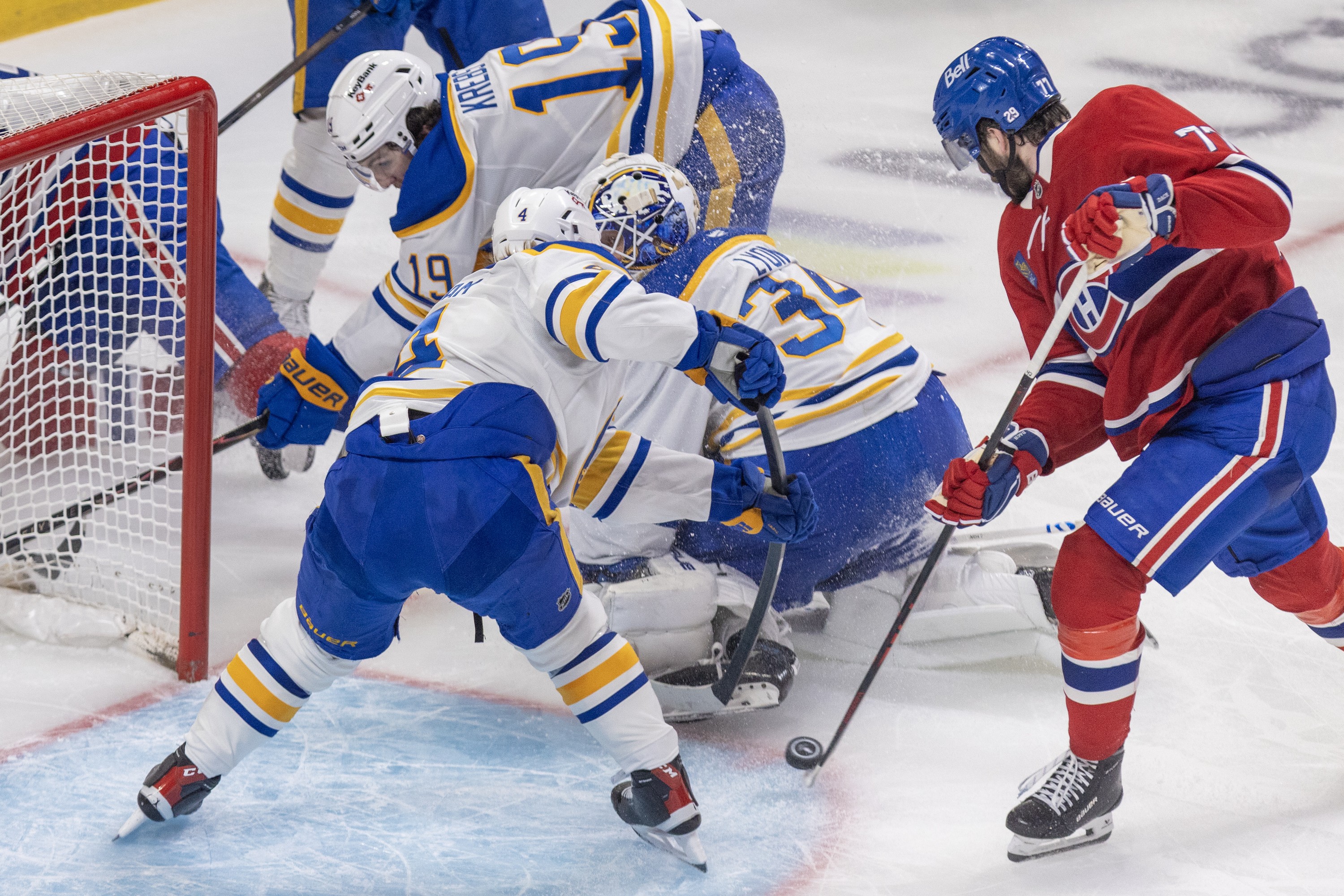 Montreal Canadiens' Kirby Dach shoots the puck past Buffalo Sabres' Bowen Byram, goalie Alex Lyon and Peyton Krebs for a goal.