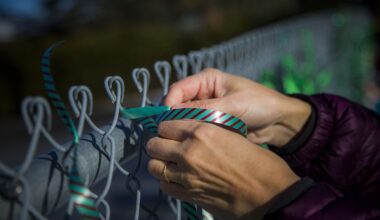 Supporters of teacher Fatemeh Anvari, who was removed from her classroom for wearing a hijab, tie ribbons on the fence at Chelsea Elementary School in 2021.