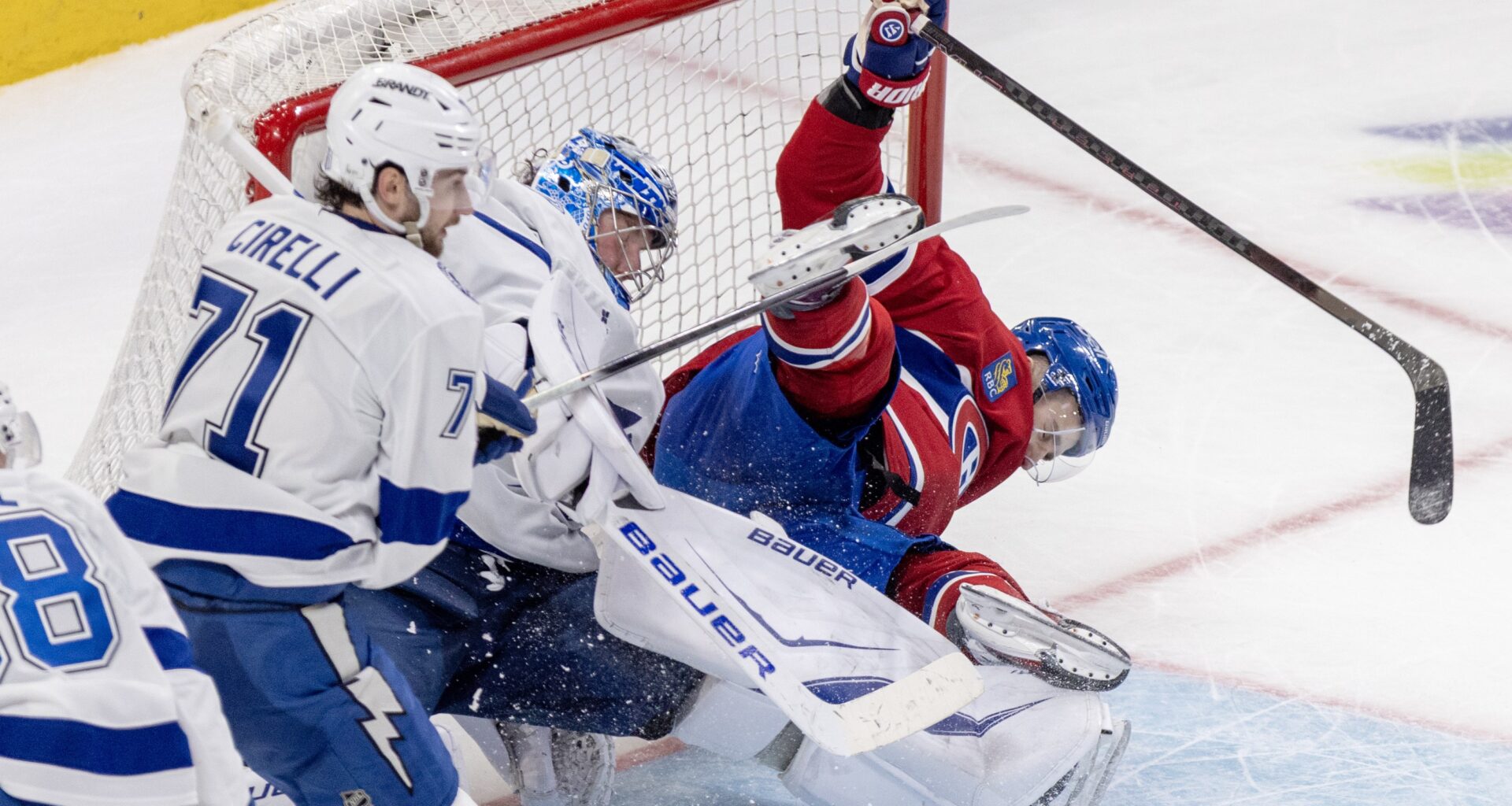 Hockey player crashes into the net.