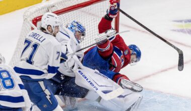 Hockey player crashes into the net.